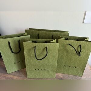 4 Gucci shopping bags
